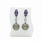 Pair of earrings with purple gemstones and face-like charms on a white display card.