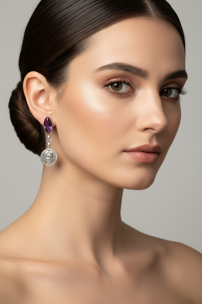Woman wearing a purple earring with a gray background