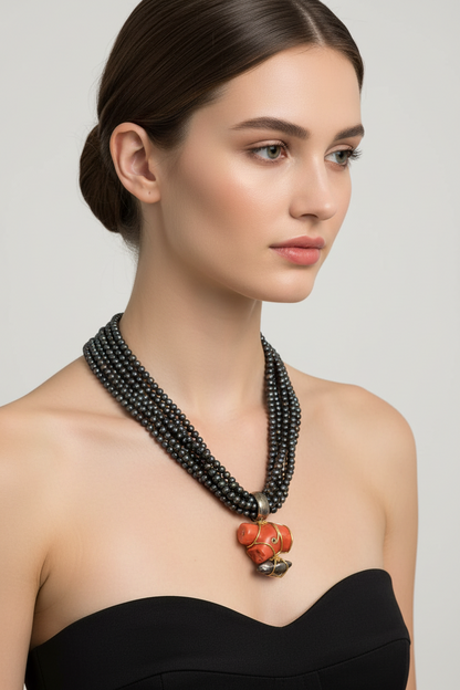 Necklace in Black Tahitian Pearls with sterling silver elements and a Coral Pendant with brilliants and 18k elements