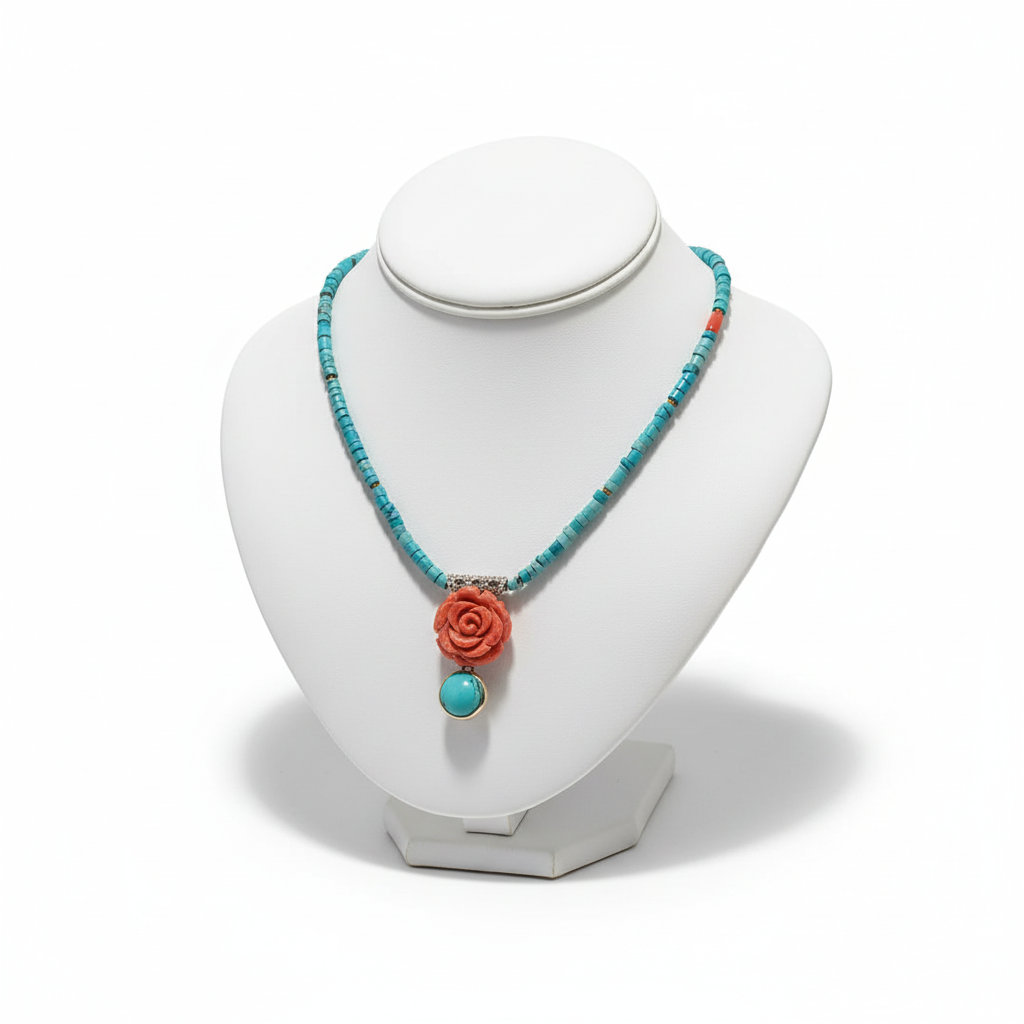 Necklace with turquoise beads and coral rose pendant on a white mannequin bust.