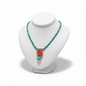 Necklace with turquoise beads and coral rose pendant on a white mannequin bust.