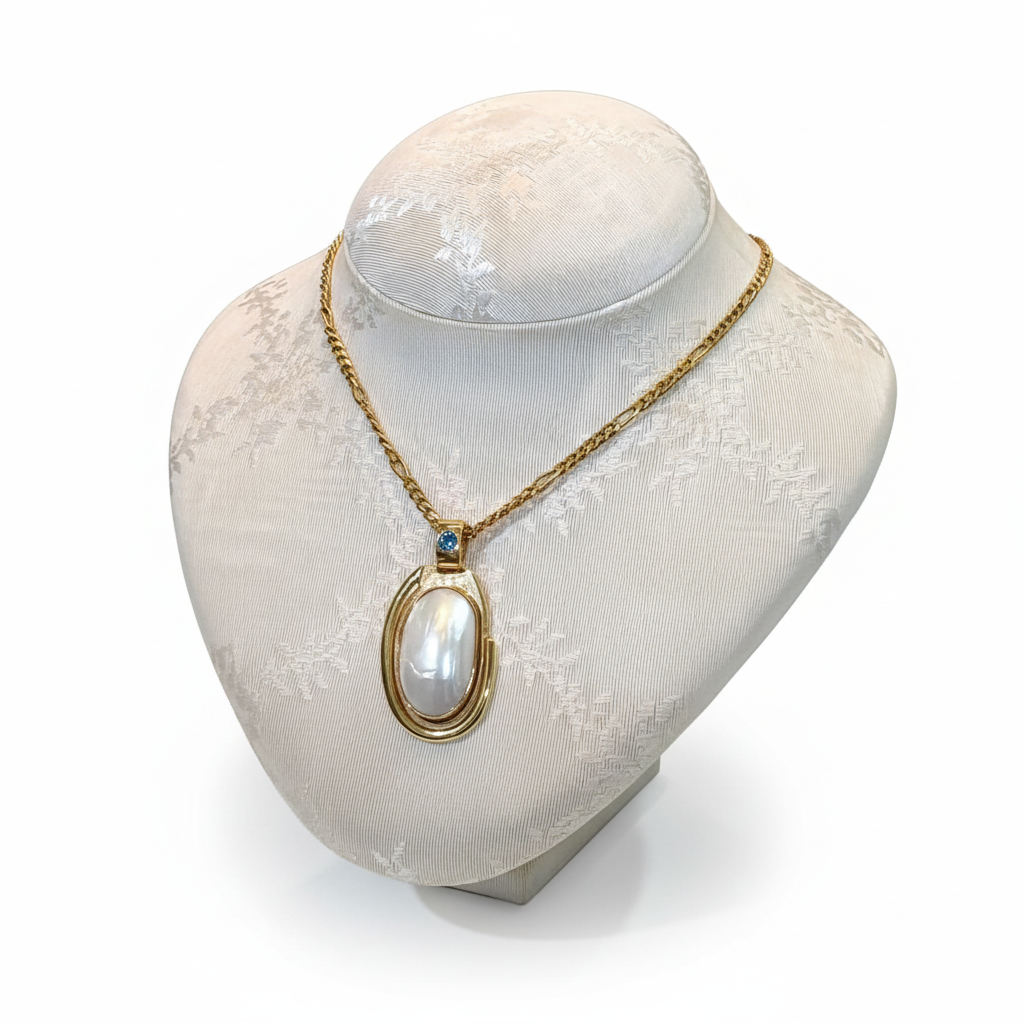 Necklace with a 18k gold medallion mother of pearl and a bleu topaz in a hand made 14k. gold chain (PE-24)