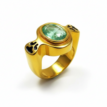 Gold ring with a green gemstone on a white background