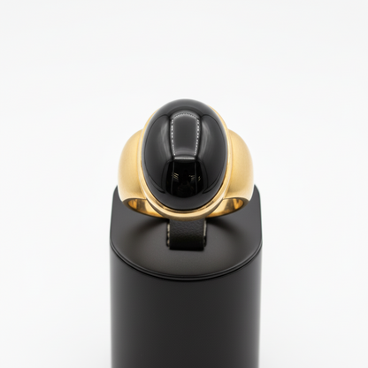 Black and gold ring on a white background