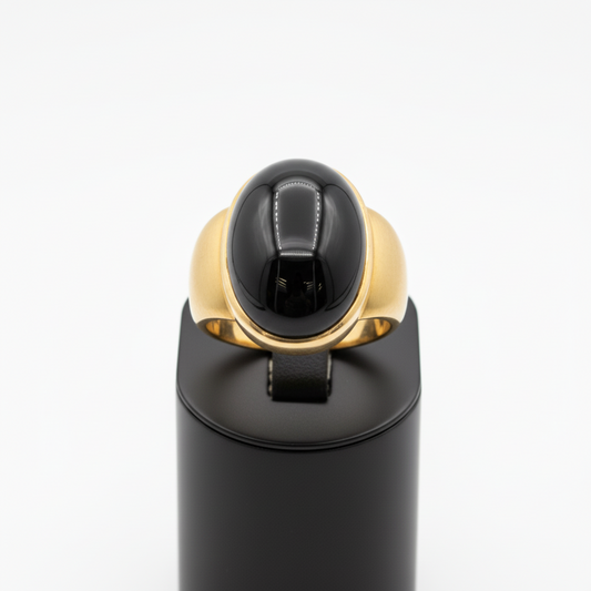 Black and gold ring on a white background