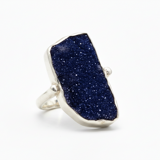 Ring with a blue stone on a white background